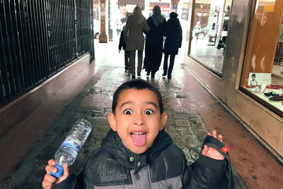 Portrait of happy boy holding camera