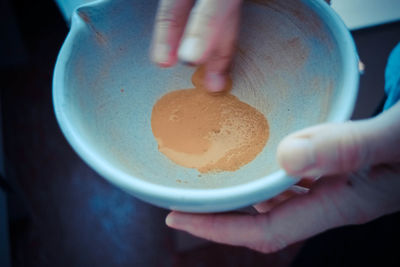 Close-up of hand holding ice cream