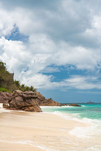 Cliffs and rocks on la digue beach, seychelles.