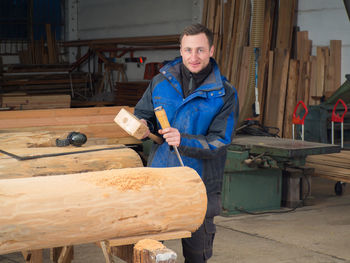 Portrait of man working on wood