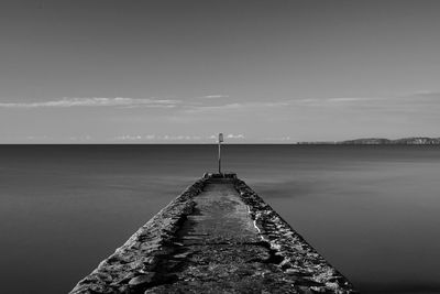 Pier over lake against sky