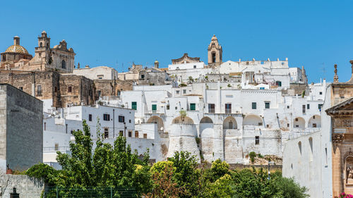 Low angle view of buildings against blue sky