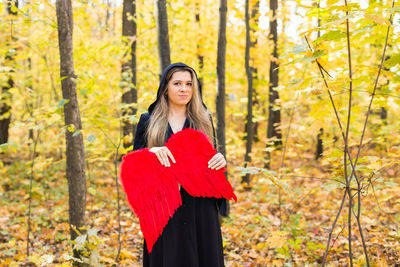 Young woman standing in forest