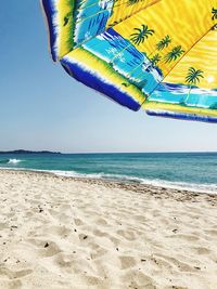 Scenic view of beach against blue sky