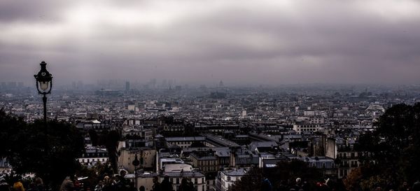 Cityscape against cloudy sky