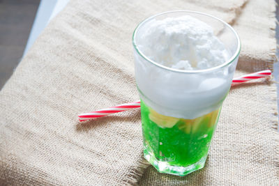 Close-up of ice cream and drink in glass on table