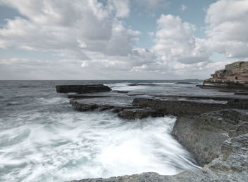 Scenic view of sea against cloudy sky