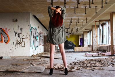 Woman standing in graffiti