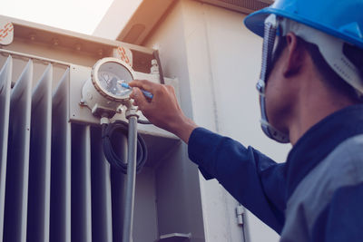 Male engineer checking meter