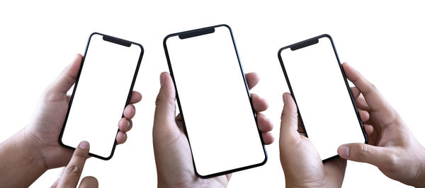 Cropped image of people using mobile phones against white background