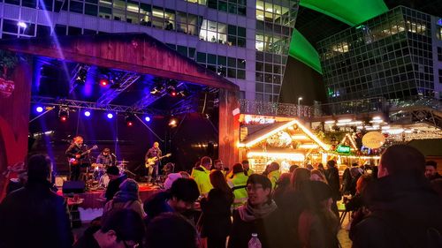 Crowd at music concert in city at night