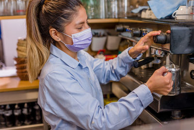 Female barista working at cafe