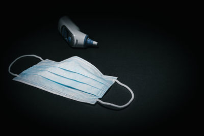 High angle view of eyeglasses on paper against black background