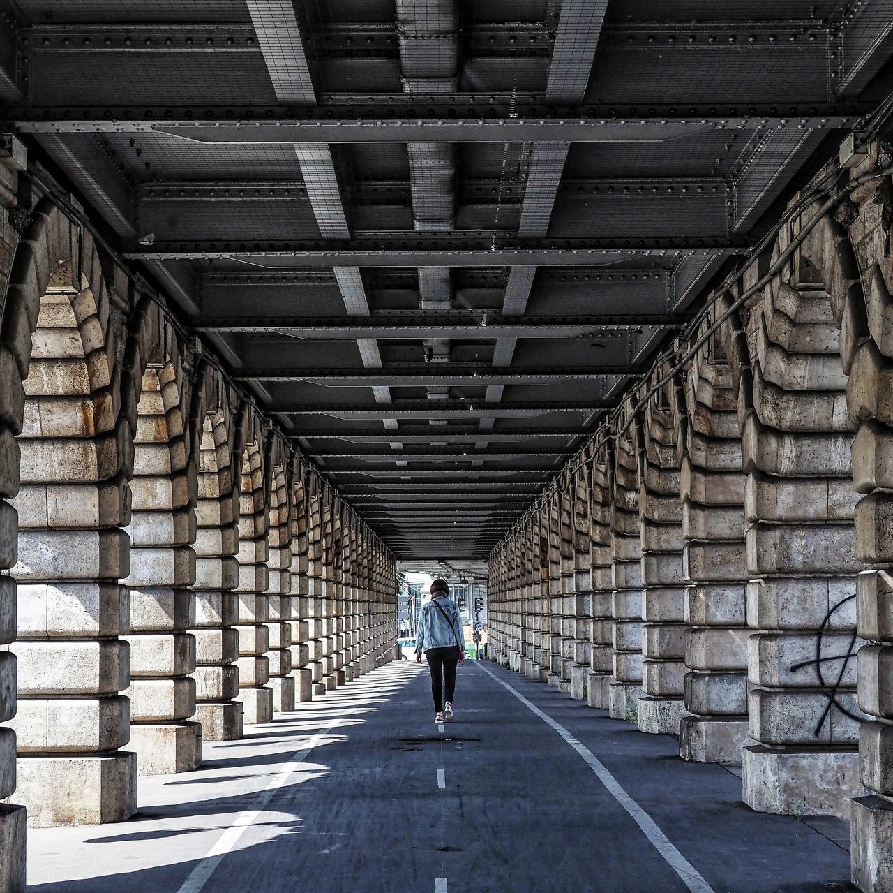 FULL LENGTH REAR VIEW OF MAN ON BRIDGE