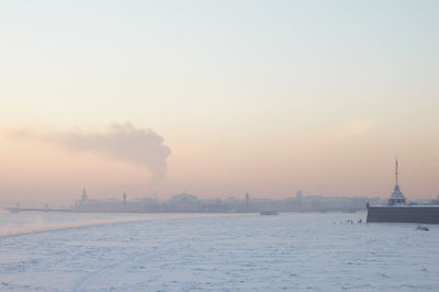 Scenic view of city during winter against sky