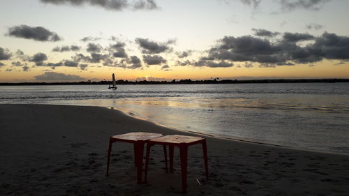 Scenic view of beach against sky during sunset