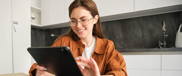 Young woman using laptop at home