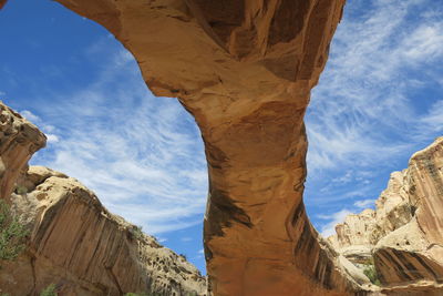 Low angle view of rocky mountains against sky