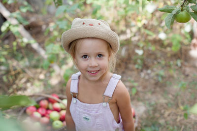 Portrait of cute girl standing against plants