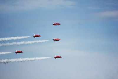 Low angle view of airplane flying against sky