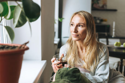 Portrait of smiling woman at home