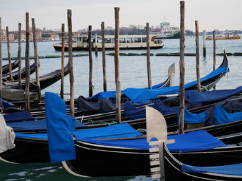 Boats moored on wooden post in city