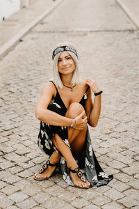 Portrait of smiling young woman sitting outdoors