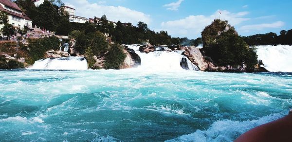 Scenic view of waterfall against sky