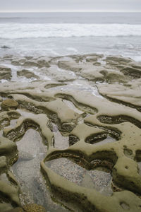 Close-up of sand on beach against sky