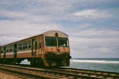 Train by sea against sky