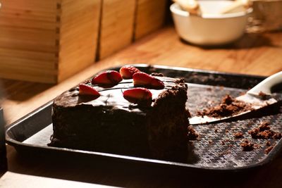 Close-up of fresh cake served in tray on table