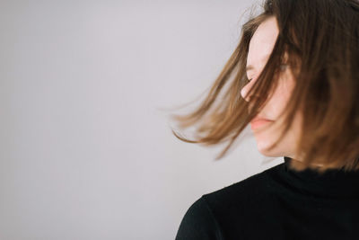 Portrait of woman against white background