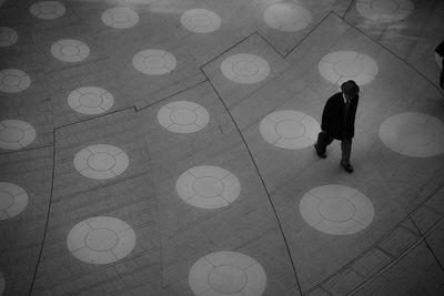 High angle view of man walking on footpath