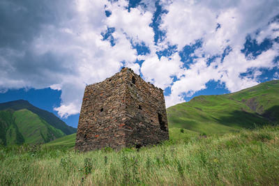 Scenic view of land and mountains against sky