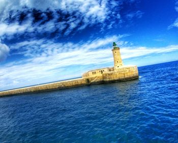 Scenic view of sea against cloudy sky