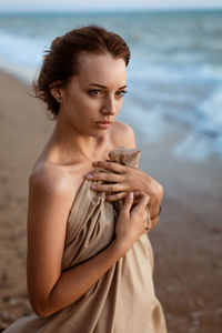 Young woman standing at beach