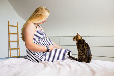 Young woman sitting on a bed