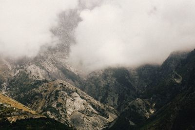 Scenic view of mountains against cloudy sky