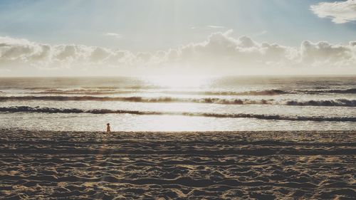 Man standing on beach against sky