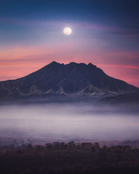 Scenic view of mountains against sky at sunset