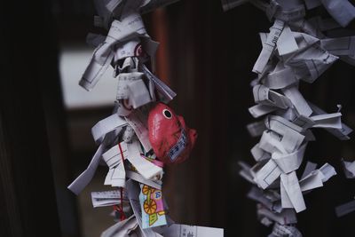 Close-up of stuffed toy hanging on paper