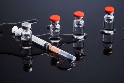 Close up vaccines and syringe on the table