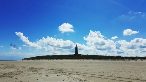 Mid distance of lighthouse at beach against sky