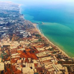 Aerial view of cityscape by turquoise sea