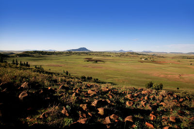 Scenic view of land against clear blue sky