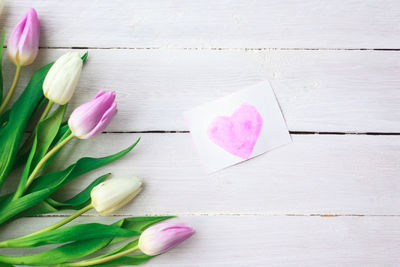 Close-up of pink rose on table
