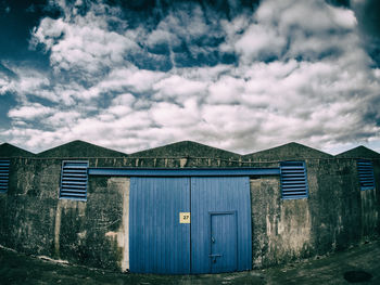 Houses against cloudy sky