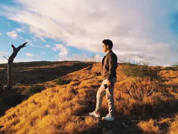 Full length of man standing on field against sky