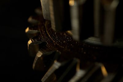 Close-up of machine part against black background