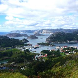 Scenic view of hidra in sea against cloudy sky